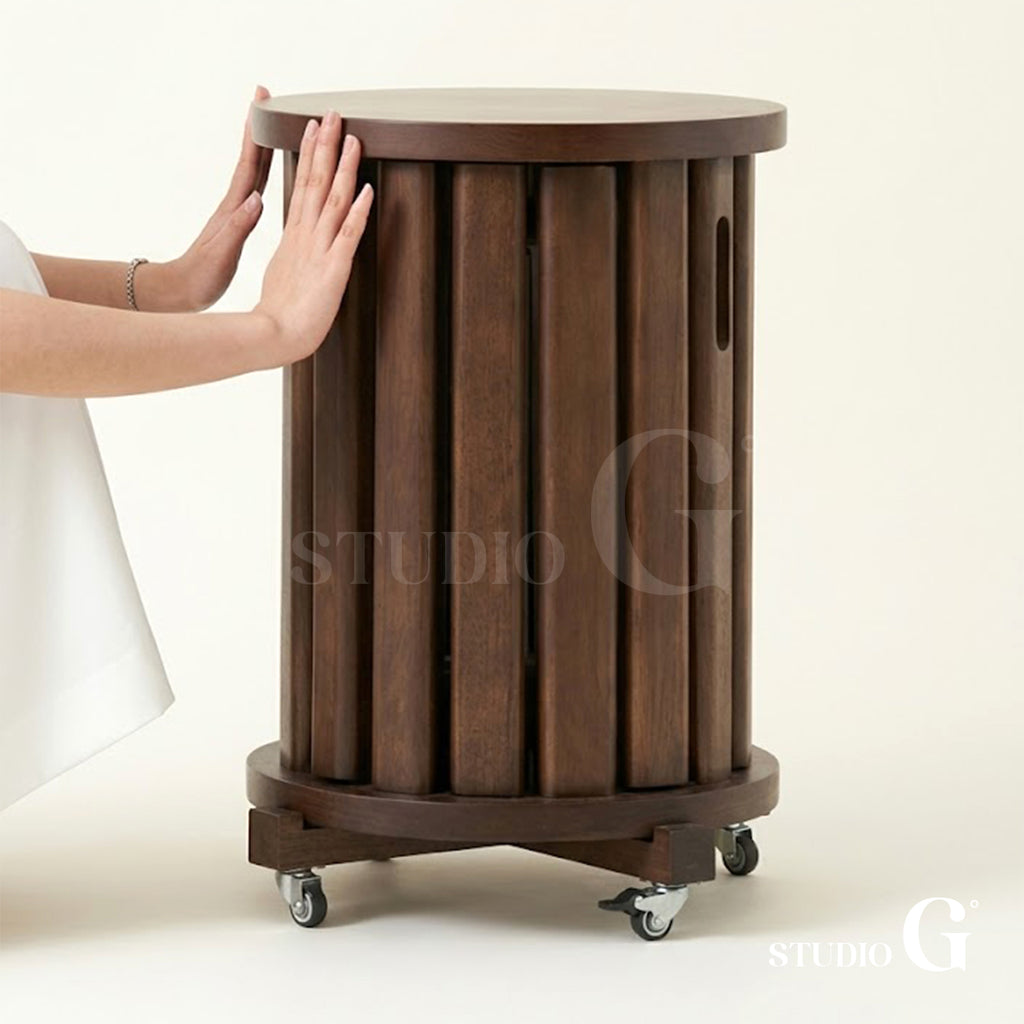 Hand resting on the Dark Brown side table with vertical wood slats and finger slots