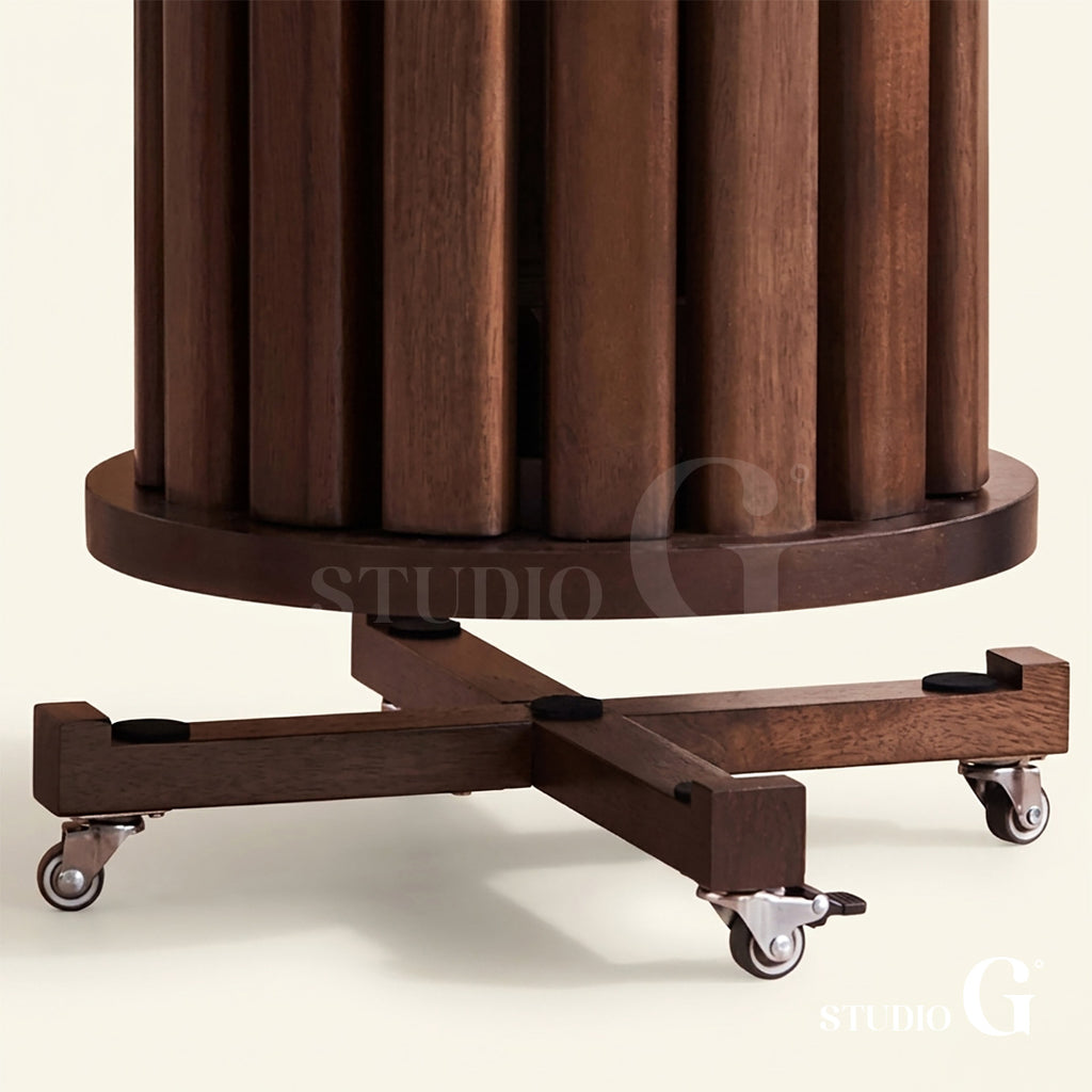 Close-up of the rolling caster base with locking wheels under the Dark Brown side table