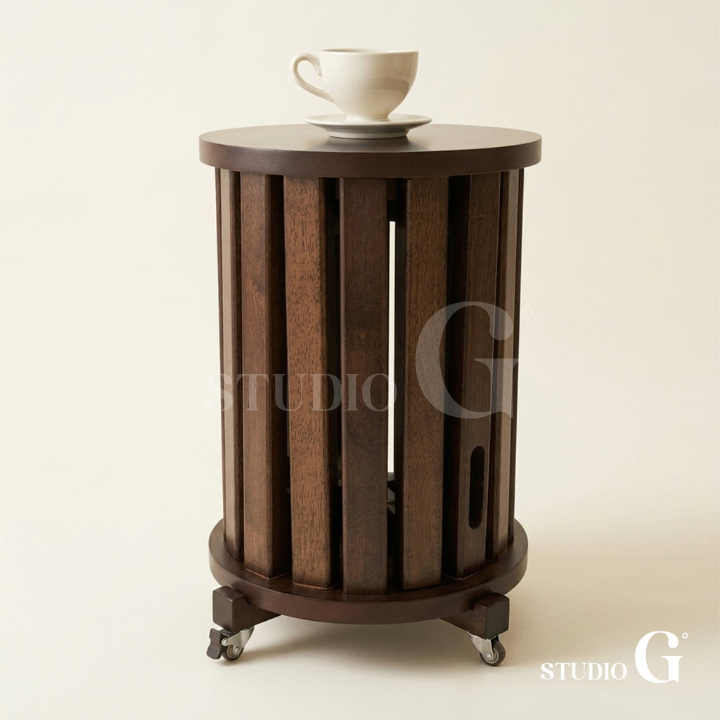 Dark Brown solid wood side table on its caster base with a coffee cup on top